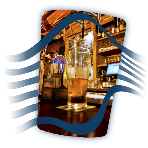 Half-drunk pint of beer on a bar in a pub